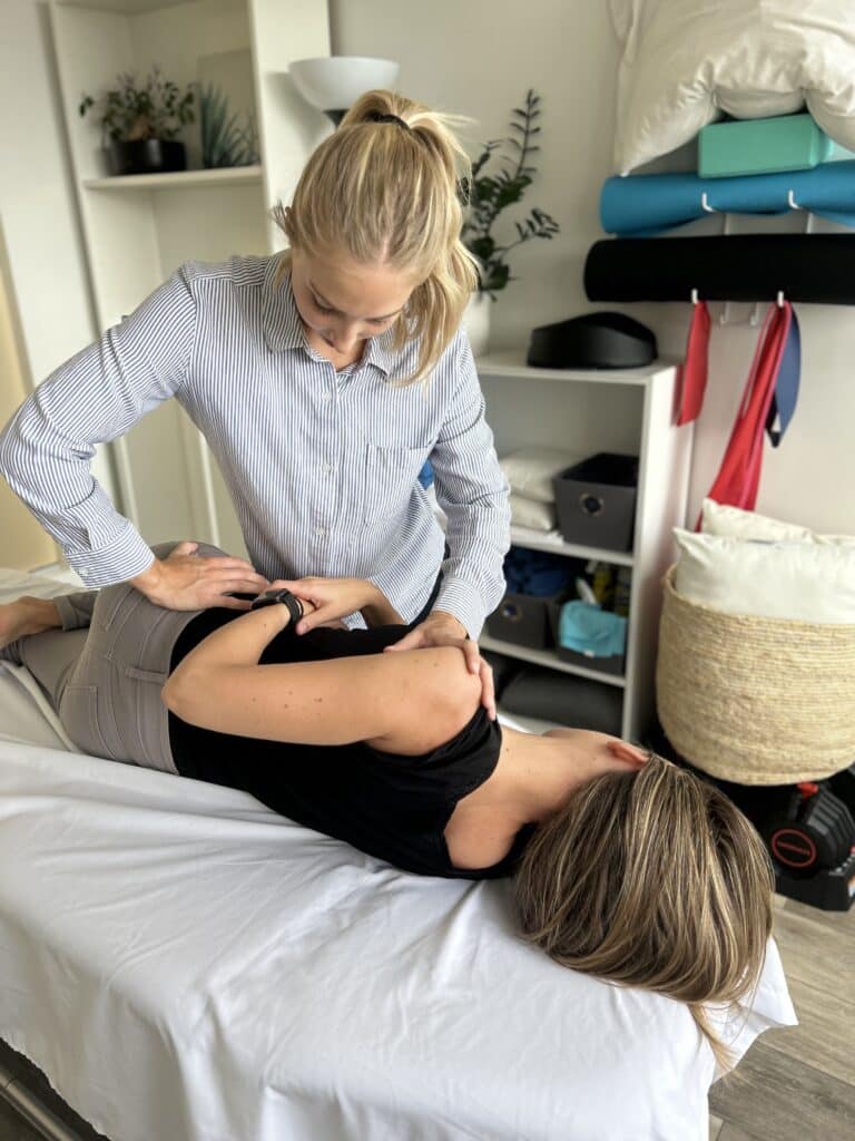 Jenna Mellor, Osteopathic Practitioner in North Vancouver, treating client with back pain